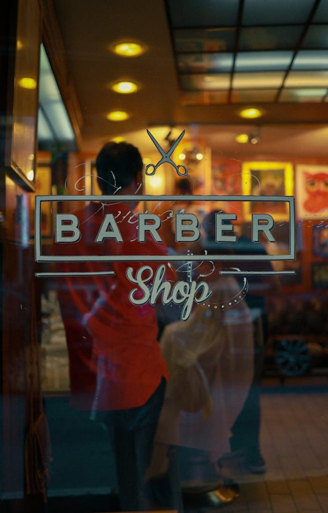 Charming barber shop with sign and reflection on a cozy street in Istanbul.