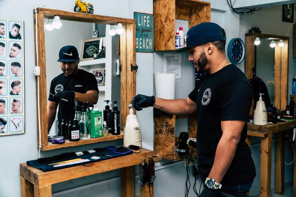 Crafting Captivating Headlines: Your awesome post title goes here A barber in a stylish shop preparing tools for a haircut. Modern interior design with mirrors and grooming products.